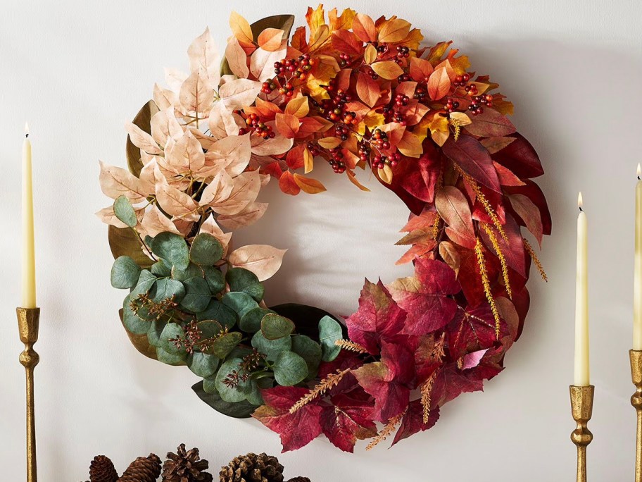 white, orange, red, and green wreath hanging on wall 