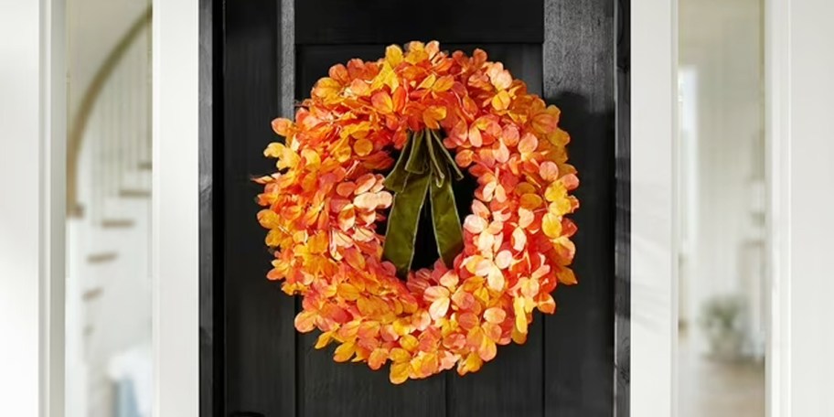 orange leaf wreath on black door 