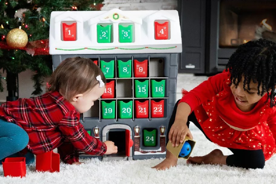toddler girls playing with a step2 advent calendar