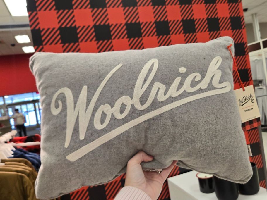 Woolrich&nbsp;Embroidered Lumbar Toss Pillow in hand in store