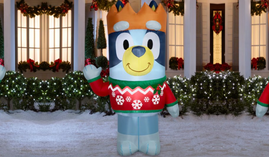 Life-size Bluey inflatable wearing Christmas sweater and positioned in front yard of home