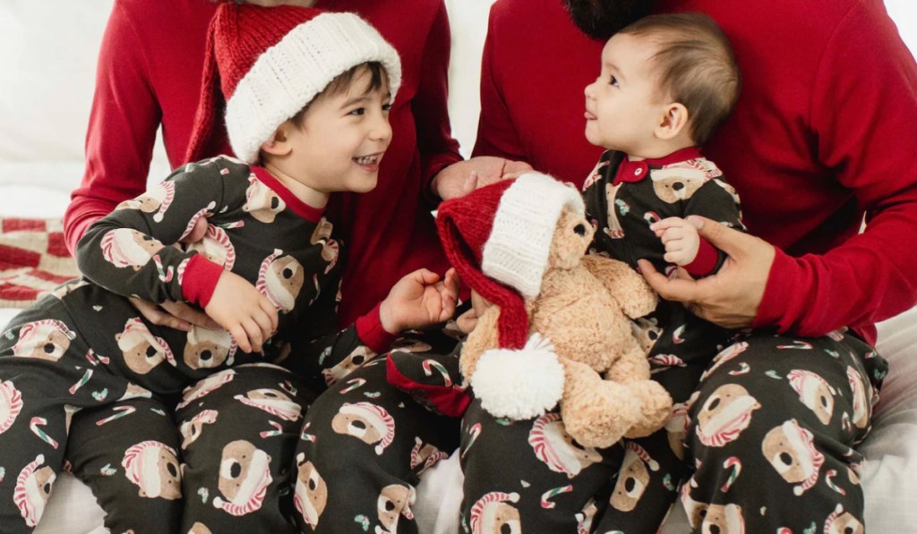 Little boys and parents wearing matching bird bees, holiday pajamas, featuring bears