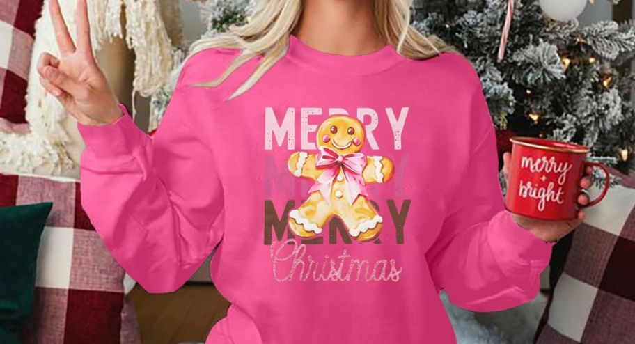 Woman wearing pink Christmas sweater