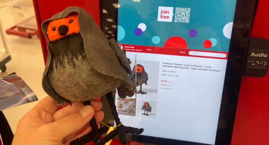 hand holding Featherly Friends Lewis & Friends 'Lewis' Halloween Bird Figurine&nbsp; in front of target scanner