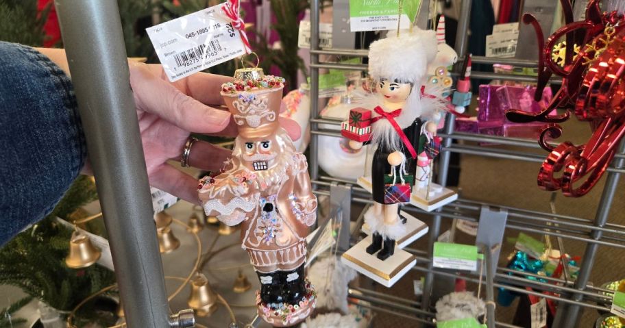 A person holding ornaments 