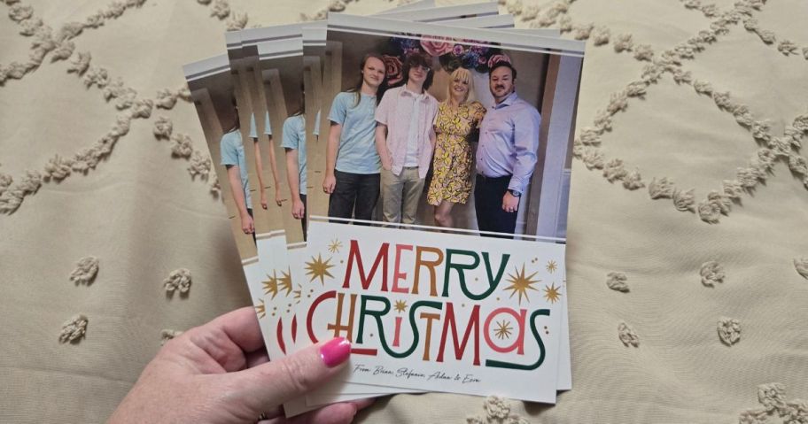 Hand holding 6 Premium Christmas Photo Cards from Walgreens