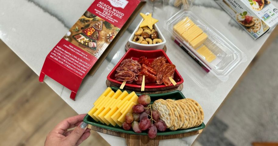 Holiday Time Acacia Wood Charcuterie Board filled with food on counter