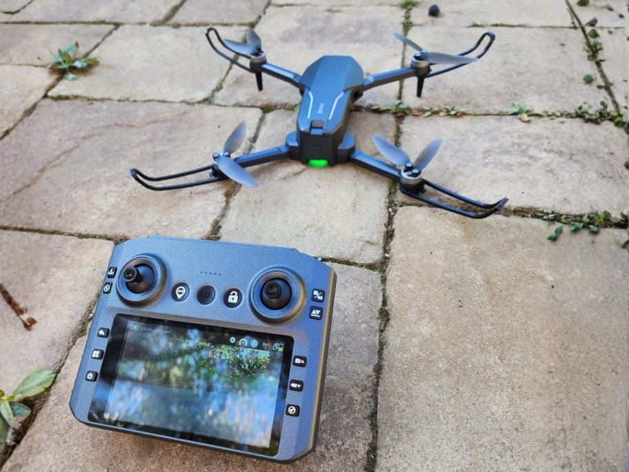 a drone and the controller sitting on concrete