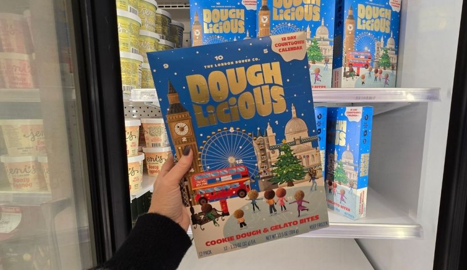 a womans hand holding a doughlicious advent calendar