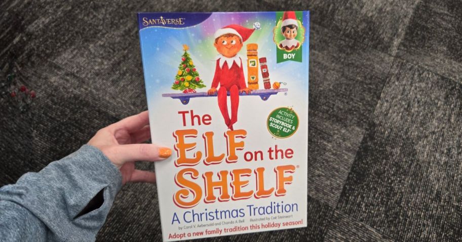 hand holding Elf on the Shelf Box Set in store