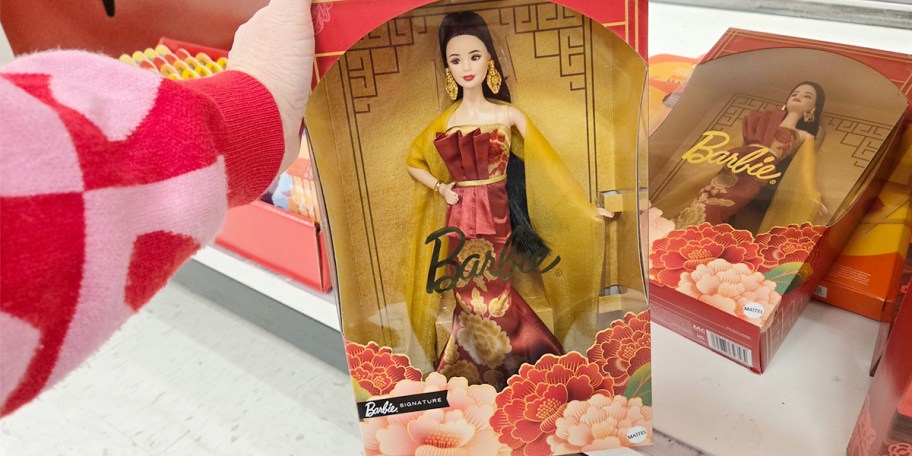 hand holding lunar new year barbie doll 