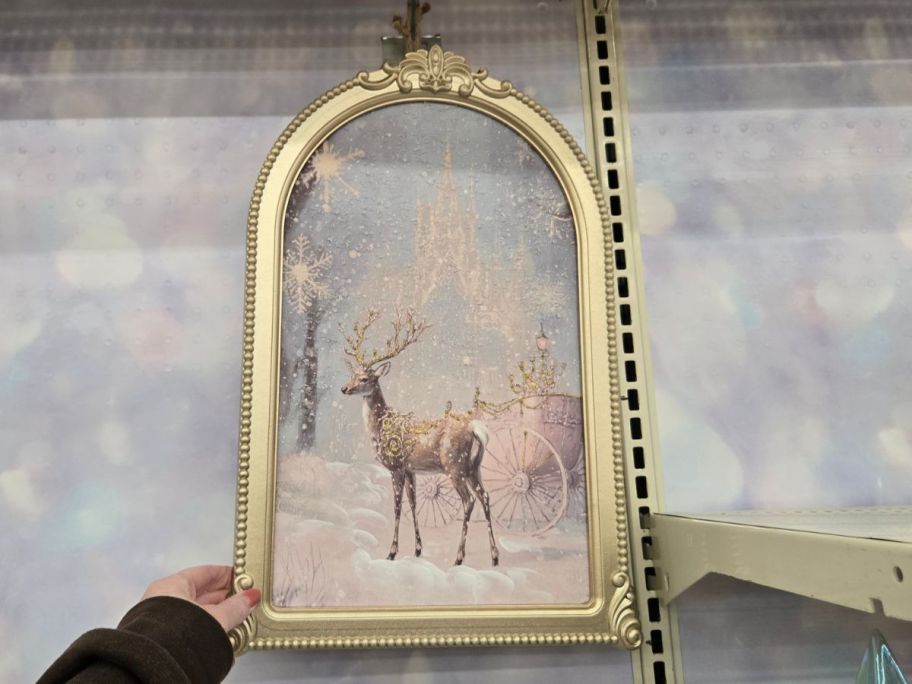 Snowy Reindeer & Cart Wall D&eacute;cor in hand in store