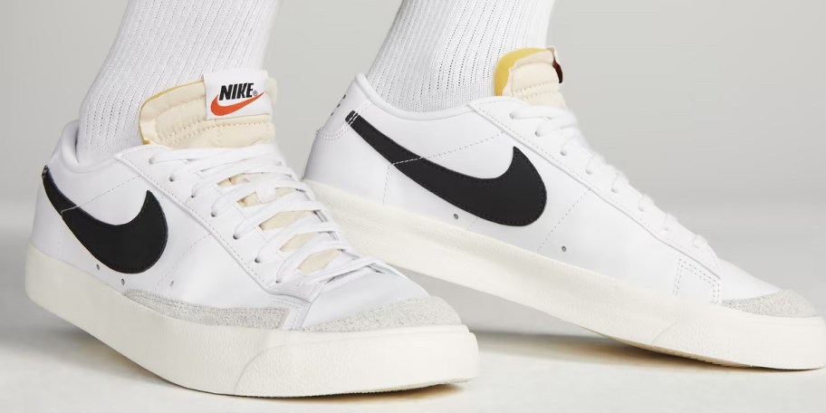 person wearing white and black nike shoes 
