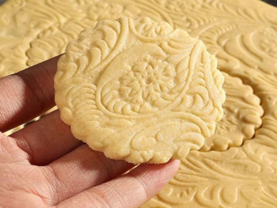 hand holding embossed cookie