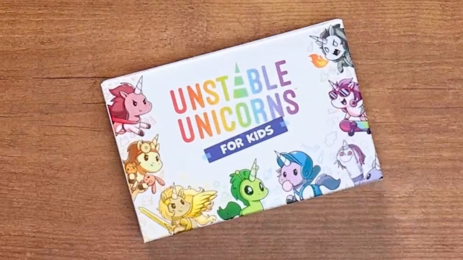 unstable unicorns card game for kids on a wooden tabletop