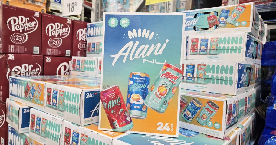 case of mini Alani energy drinks on top of a stack of more cases
