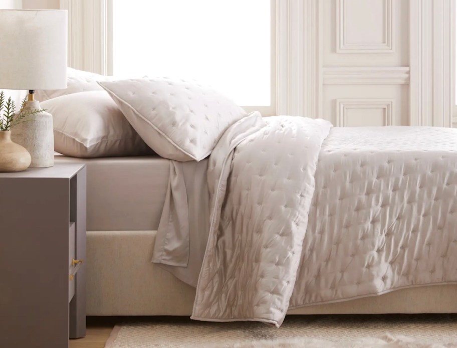 cream quilt on bed