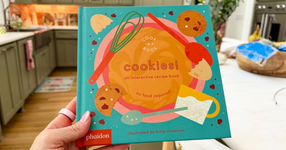hand holding an interactive kids cookies cookbook