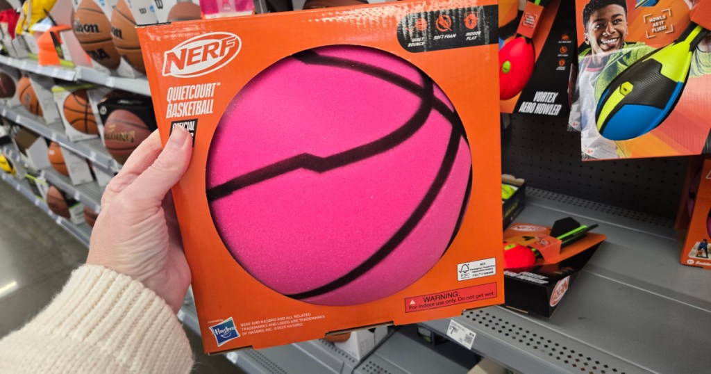 Person holding up hot pink, silent basketball inside Walmart store