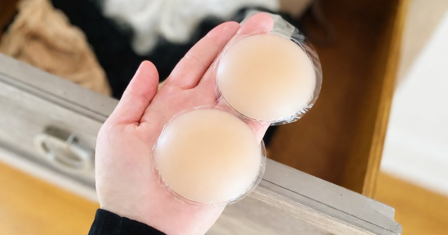 hand holding nude sticky nipple covers
