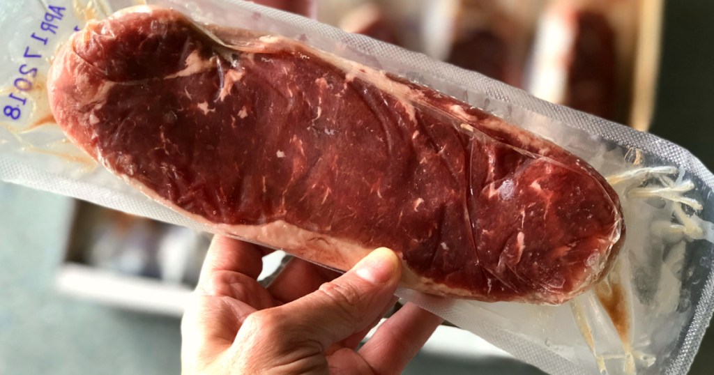 Person holding up freezer sealed steak fillet