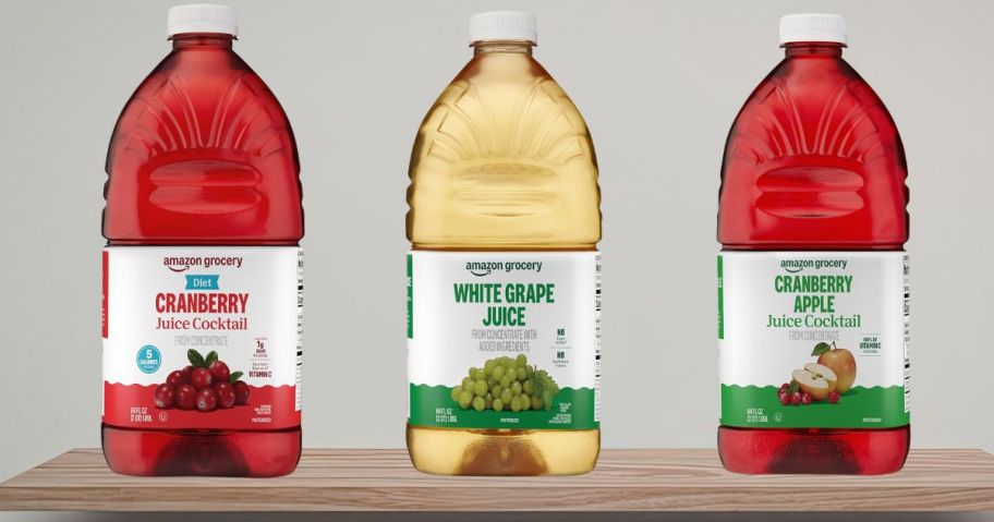three bottles of amazon grocery juice on shelf
