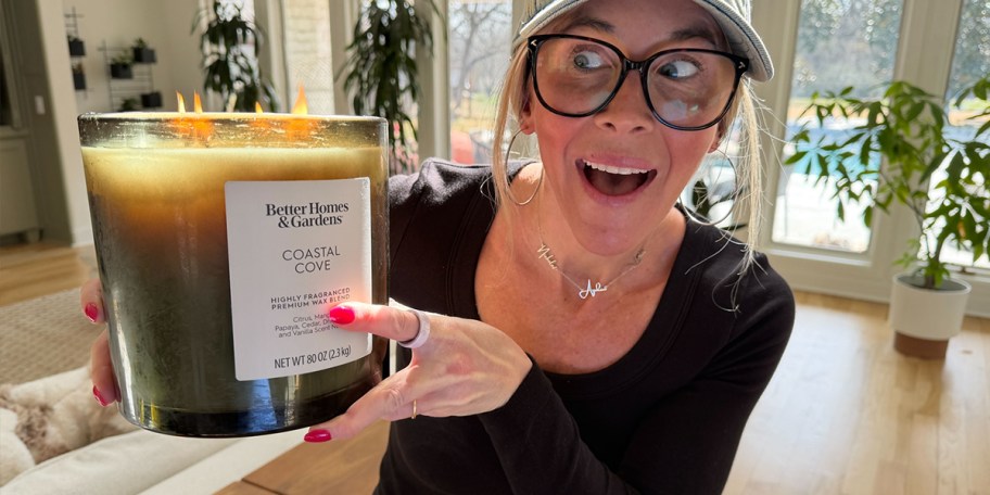 woman holding large green candle 