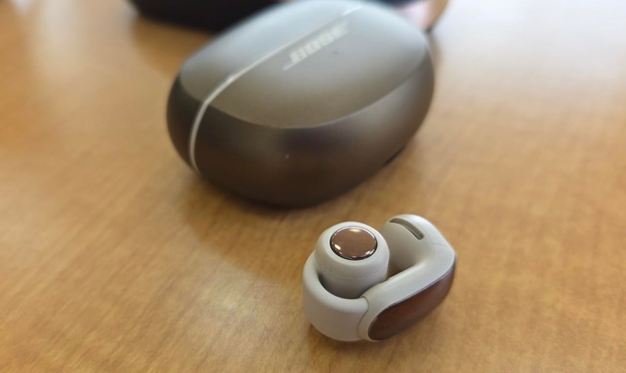 bose open earbud on wood table with case