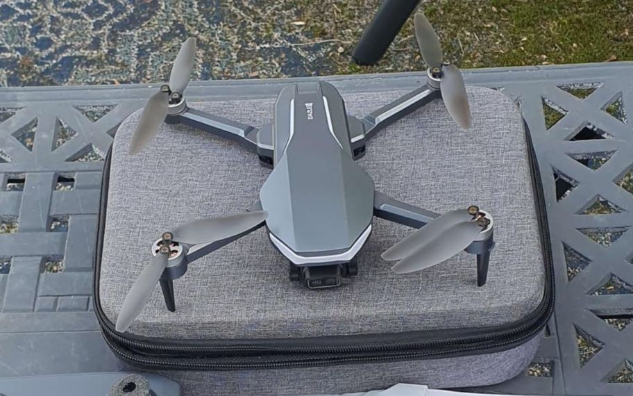 Drone displayed on top of the table with a carrying case underneath