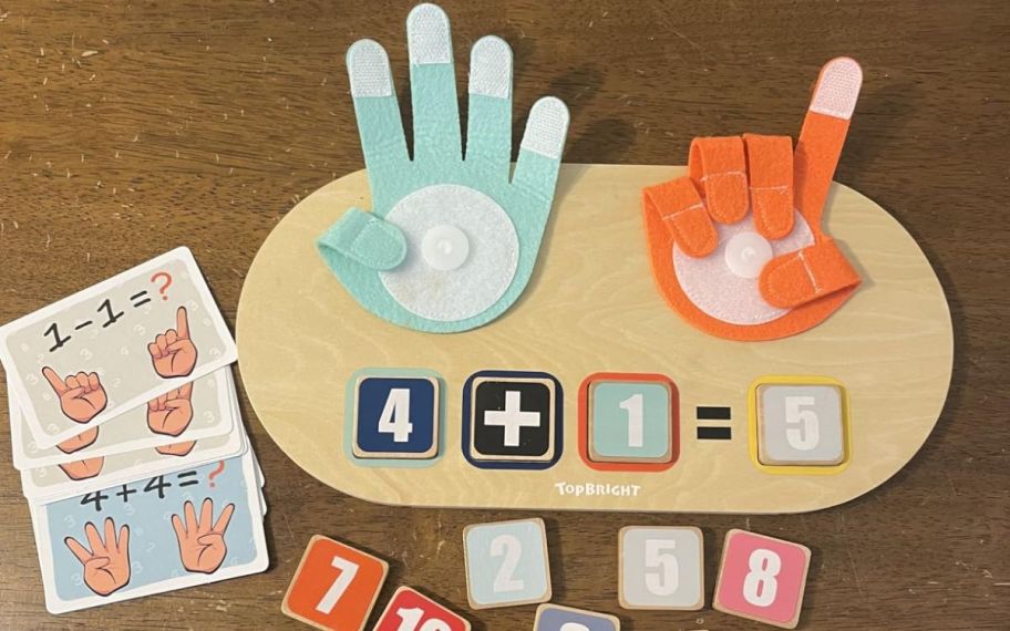 hand counting toy on top of the table with blocks and paper