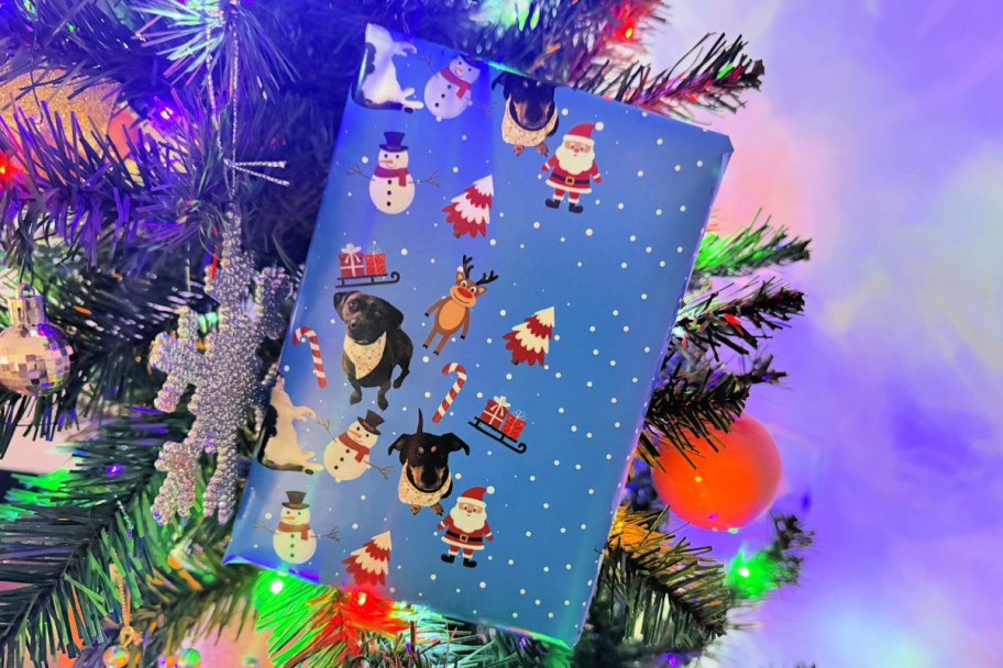 holiday wrapping paper featuring Santa Claus and dogs in a Christmas tree