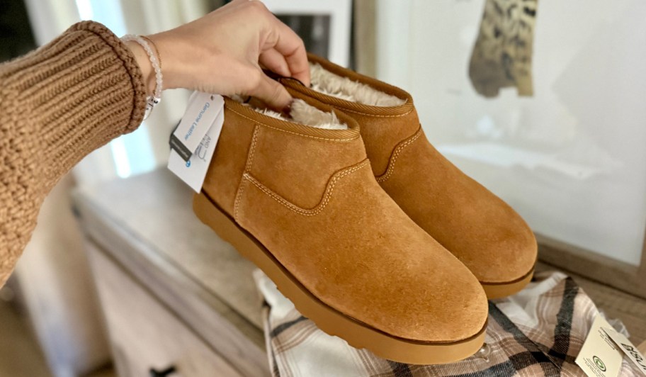 hand holding tan walmart boots