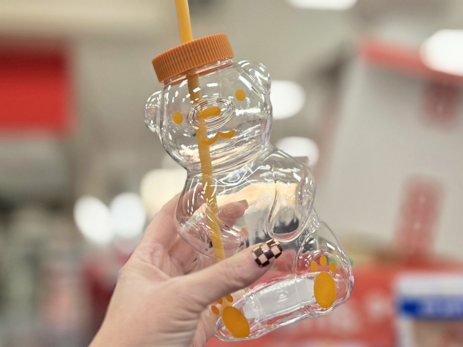 hand holding up a bear sipper cup