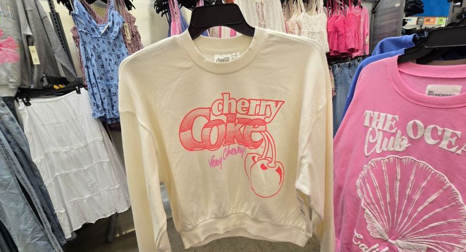 Cherry coke sweater displayed at the store