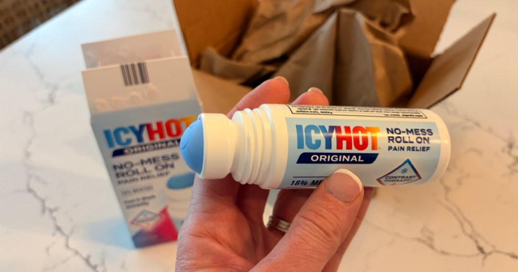 Hand holding icy hot roll on applicator