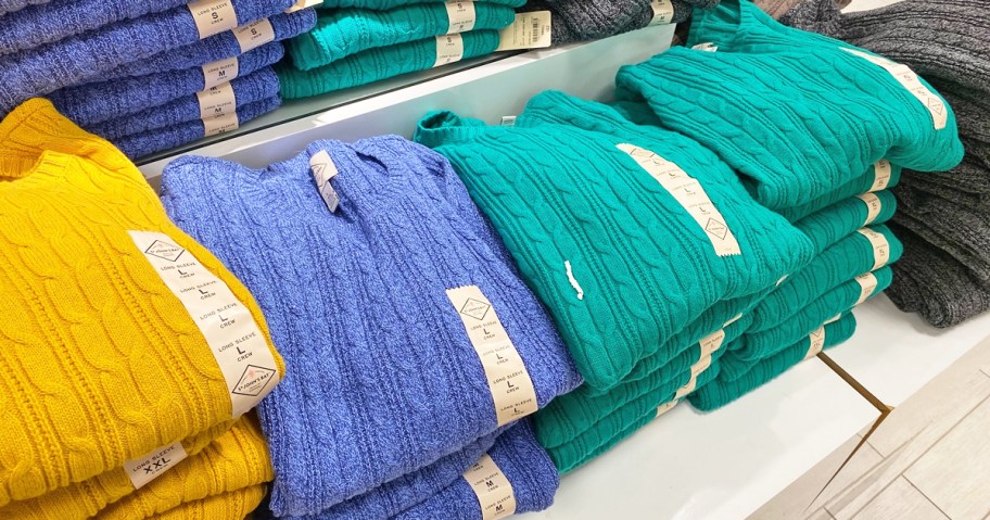 different colored sweaters on display in jcpenney