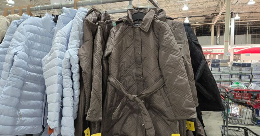 Various women's coats displayed in a store