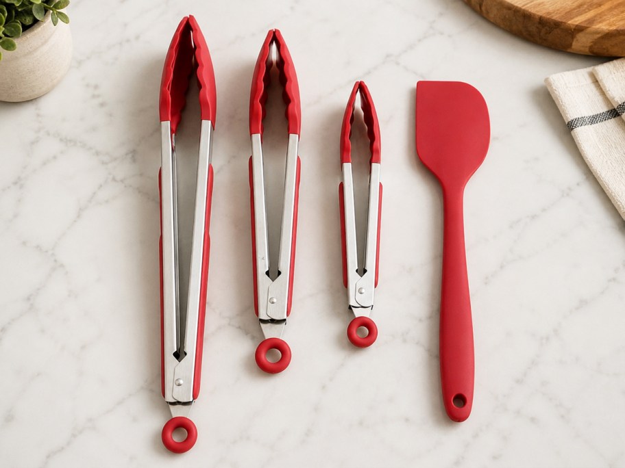 red silicone tongs and spatula on kitchen counter