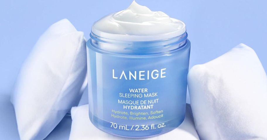 Laneige sleep mask on top of pillows in white