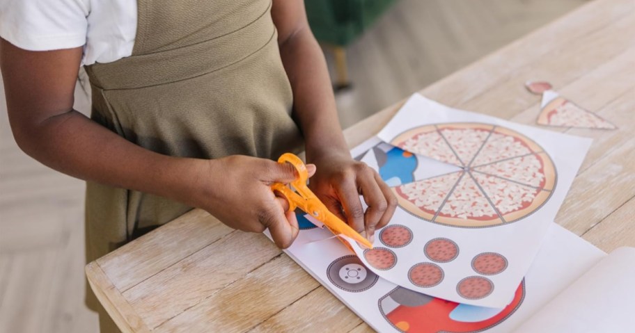 girl cutting images from paper