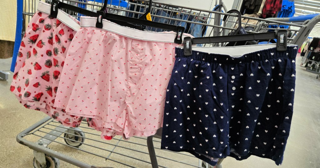 Three different patterns of no boundaries boxer shorts hanging on Walmart cart