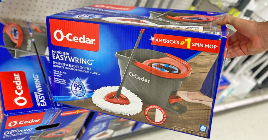 hand grabbing an O-Cedar Spin Mop box from shelf