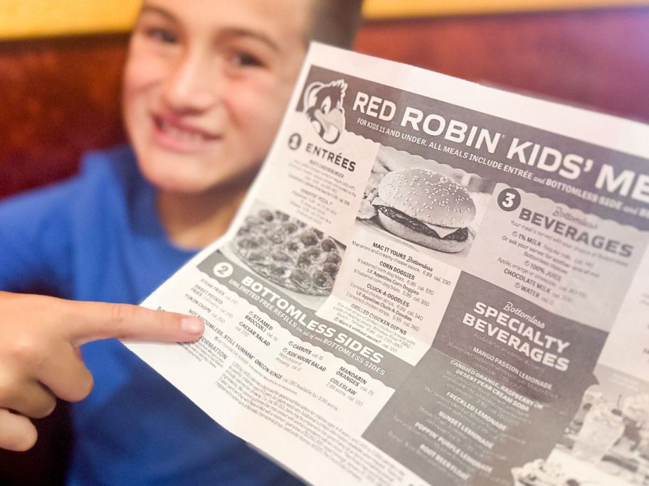 Boy pointing to the bottomless sides on a Red Robin Kids Meal Meni