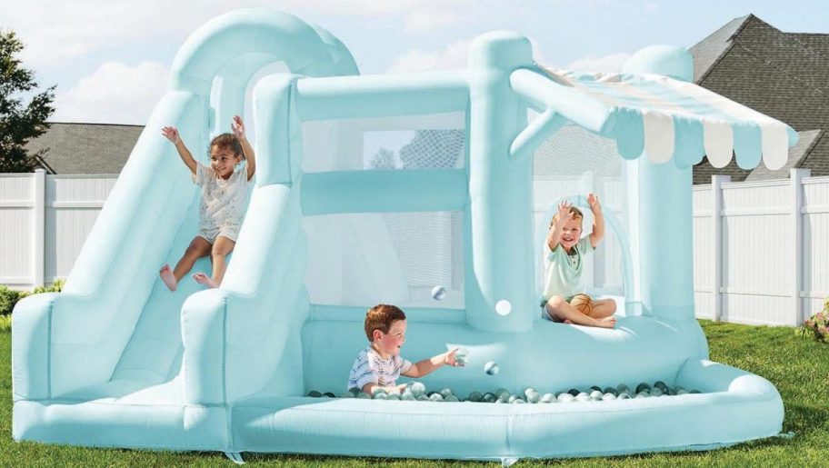 Blue Sam's club slide with children on it 