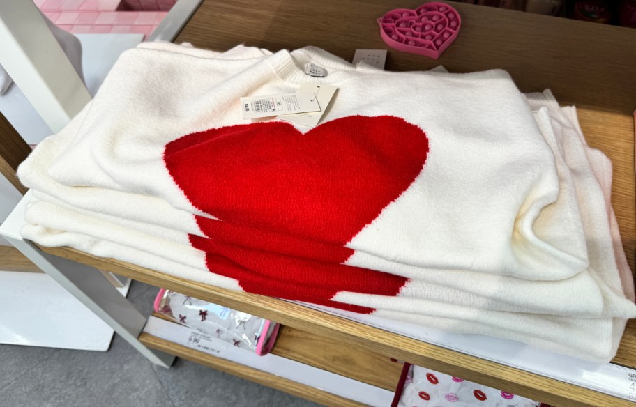 Pullover Heart Sweater folded on a shelf