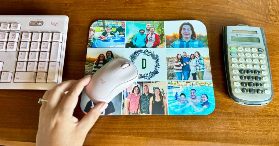 hand grabbing a mouse on top of a photo mousepad