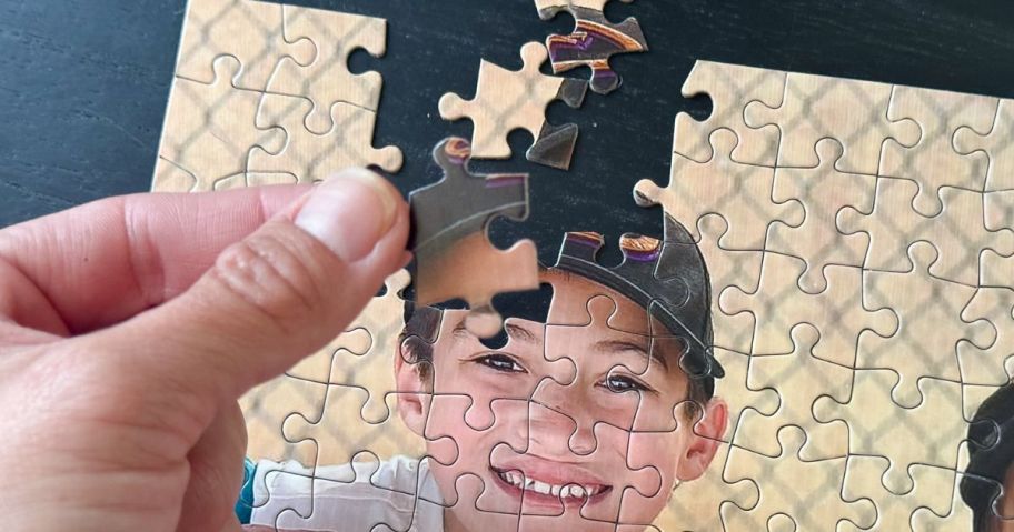 hand holding Walgreens puzzle set
