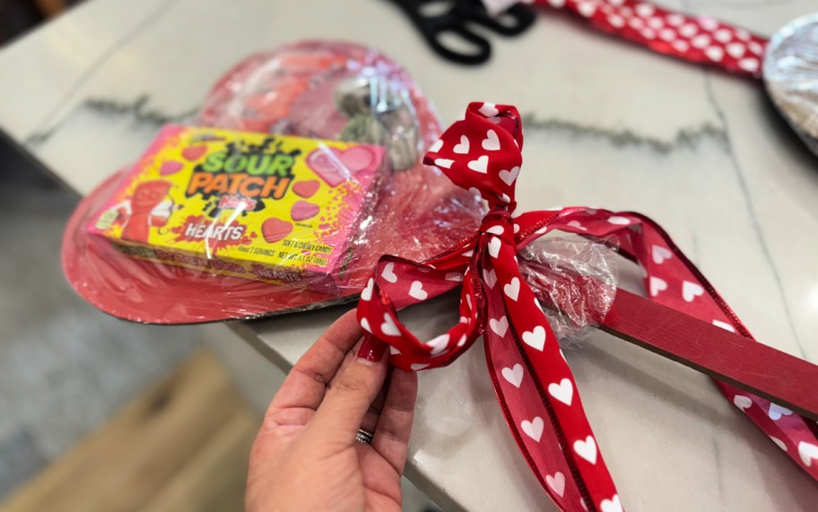 adding a bow to heart stake gift 
