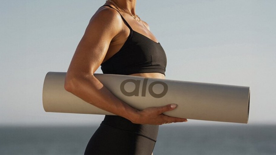 a woman carrying a yoga mat