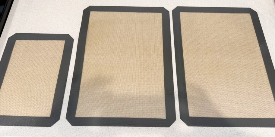 three tan and gray silicone mats 